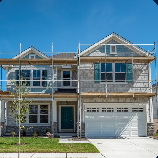 Newly built two-story house with scaffolding being finished